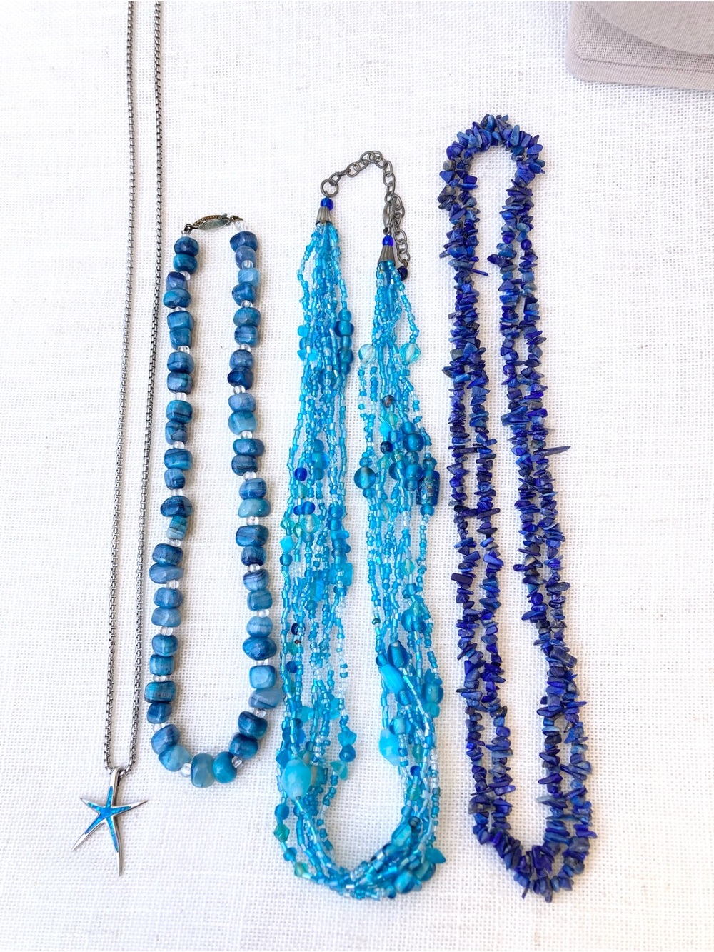 Bundle of beaded stone and glass beachy mermaid layering necklaces